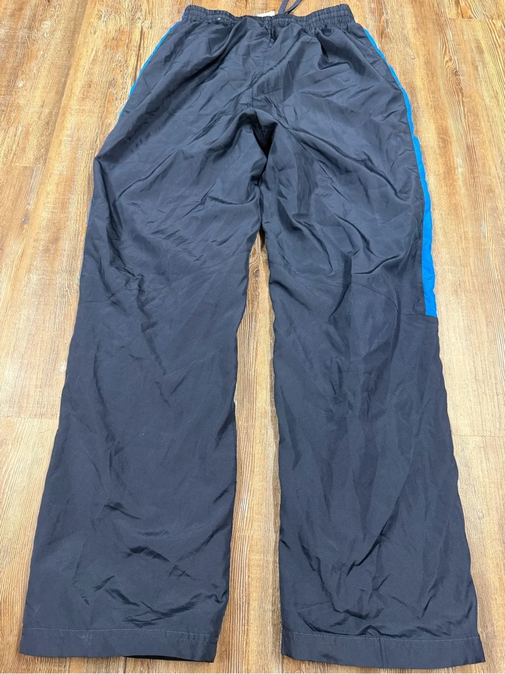 Vintage Russell Athletic navy blue track pants with blue side stripe, size M